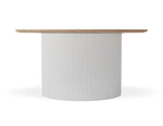 A modern round dining table featuring a fluted white cylindrical pedestal base and a light natural wood top, shown against a plain white background.
