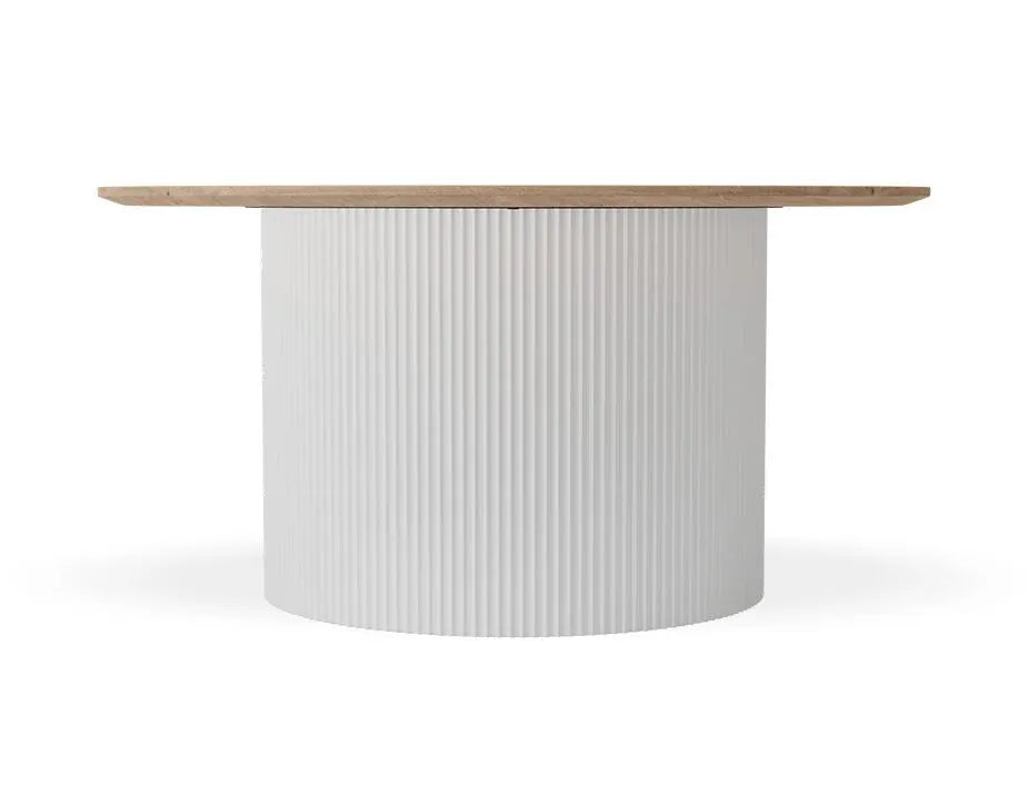A modern round dining table featuring a fluted white cylindrical pedestal base and a light natural wood top, shown against a plain white background.