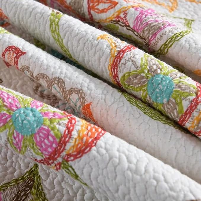 Rolls of fabric with colorful floral patterns on a white background