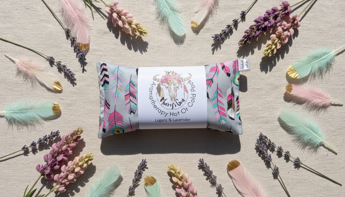 heat pack with a label surrounded by dried lavender and feathers on a neutral background
