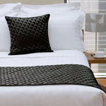 Black textured Regency Black square cushion with geometric design against white bedding