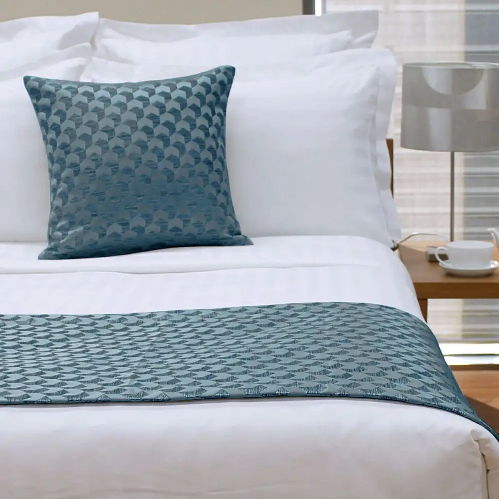 Teal quilted bed runner and matching pillow enhancing the Jason Regency Ocean Square Cushion