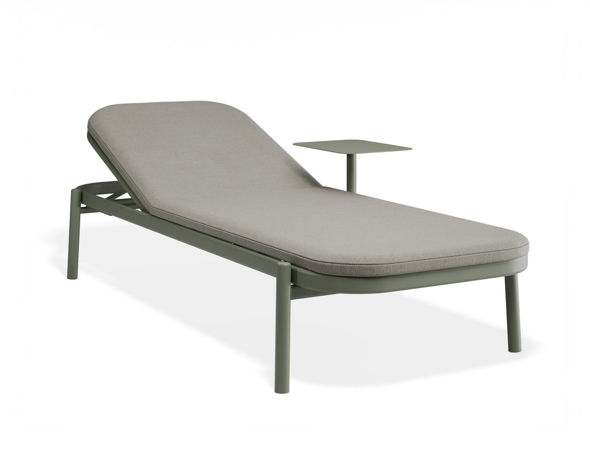 An outdoor chaise lounge chair with a light gray cushioned seat and backrest, supported by a muted green metal frame with integrated leg supports and a small matching side table, shown on a white background.