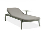 An outdoor chaise lounge chair with a light gray cushioned seat and backrest, supported by a muted green metal frame with integrated leg supports and a small matching side table, shown on a white background.