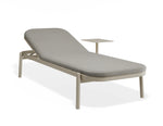 A modern outdoor chaise lounge chair with a light gray cushioned seat and backrest, supported by a light beige metal frame with integrated legs and a matching side table, shown on a white background.