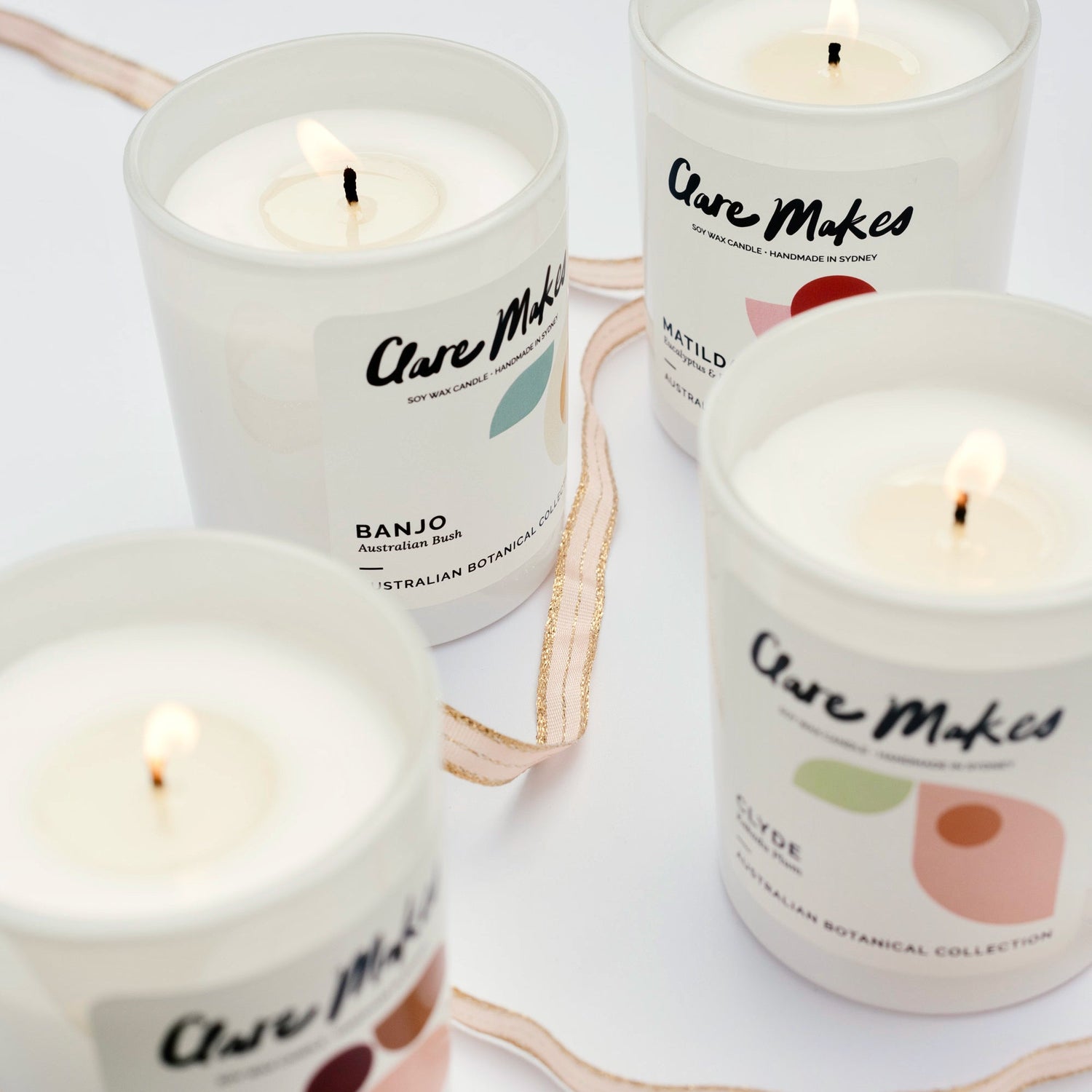Clare Makes medium soy candle in a reusable gloss white glass jar with a branded dust cover