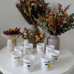 Clare Makes medium soy candle in a reusable gloss white glass jar with a branded dust cover
