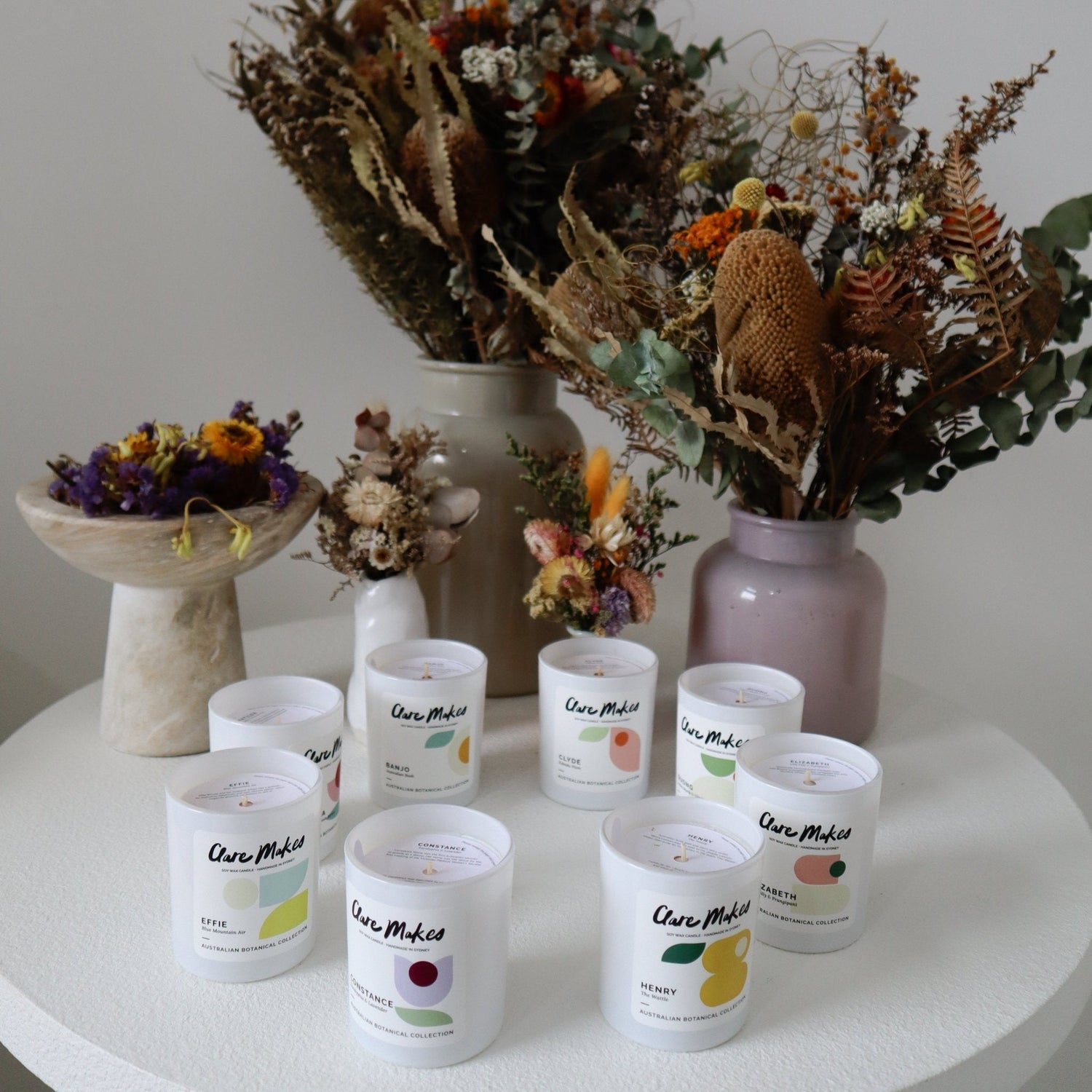 Clare Makes medium soy candle in a reusable gloss white glass jar with a branded dust cover