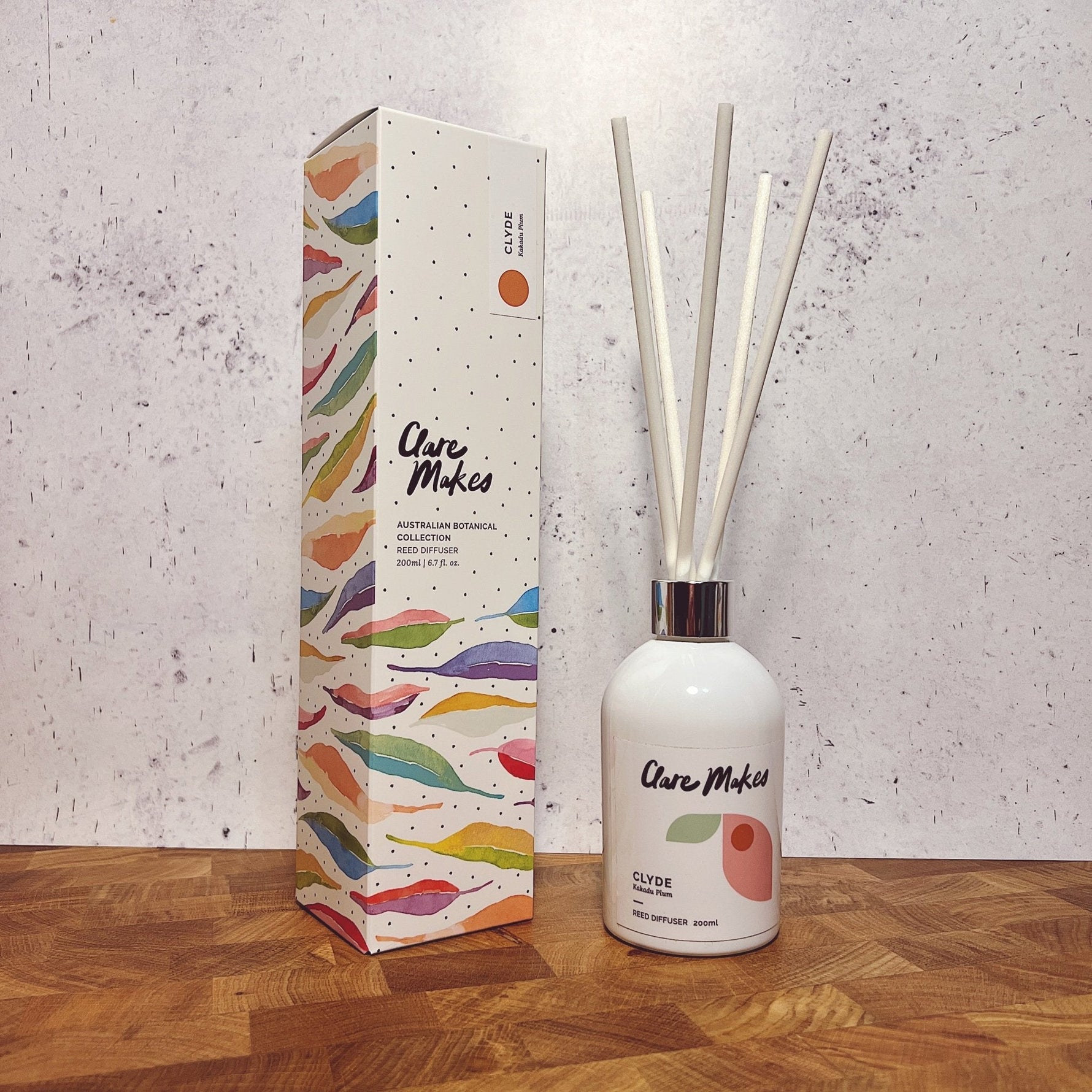 Clare Makes 200ml reed diffuser in a gloss white glass bottle with silver collar and white reeds