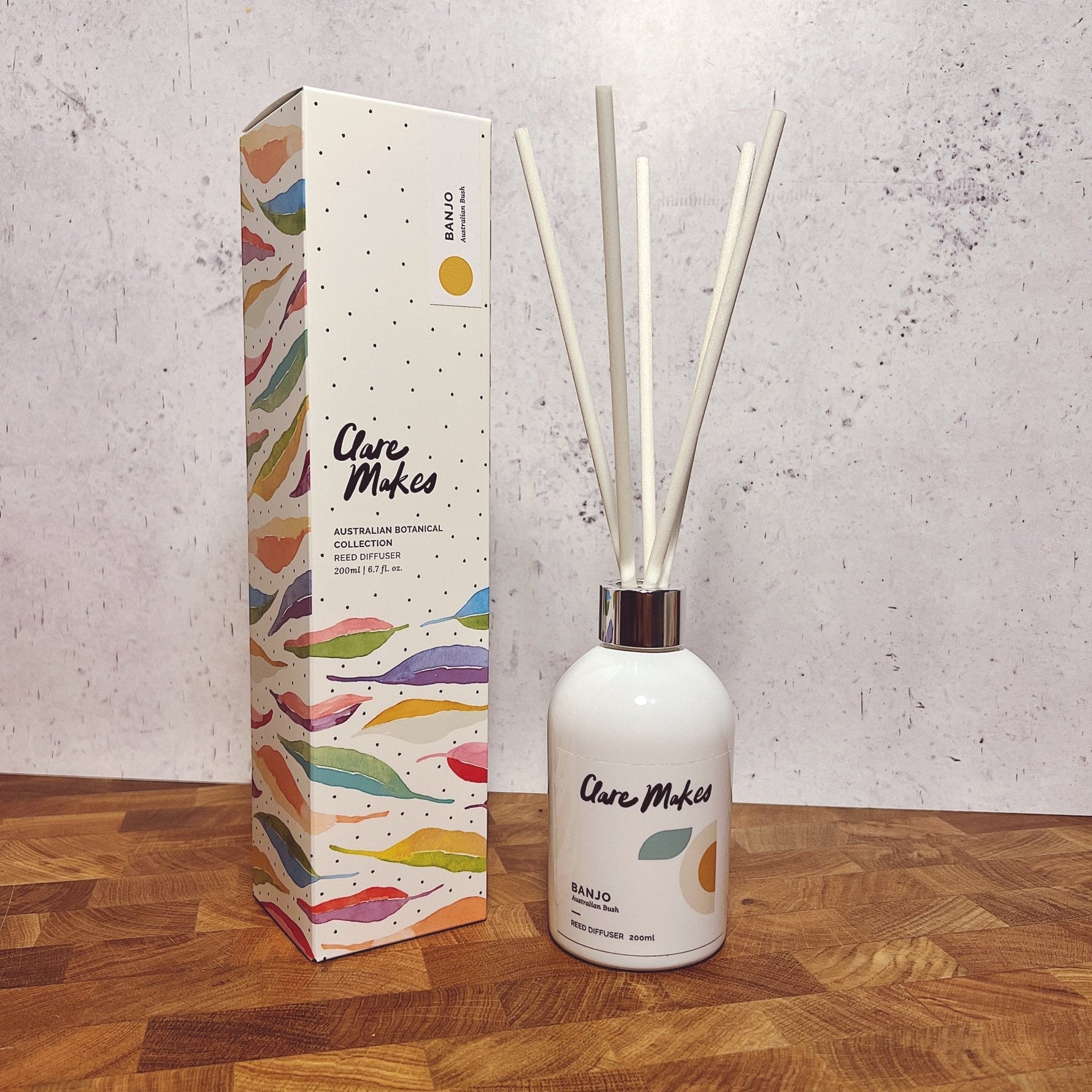 Clare Makes 200ml reed diffuser in a gloss white glass bottle with silver collar and white reeds