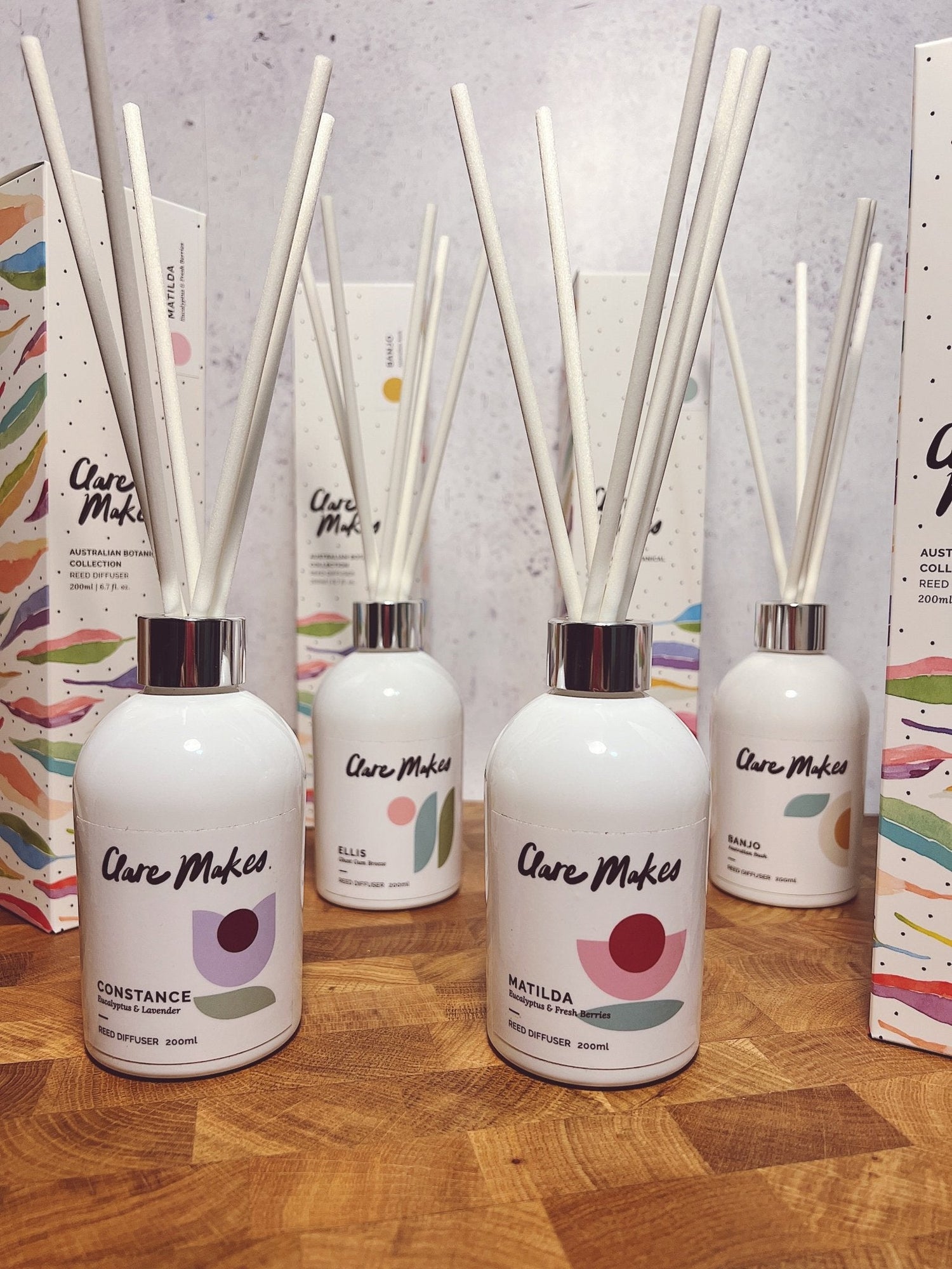Clare Makes 200ml reed diffuser in a gloss white glass bottle with silver collar and white reeds