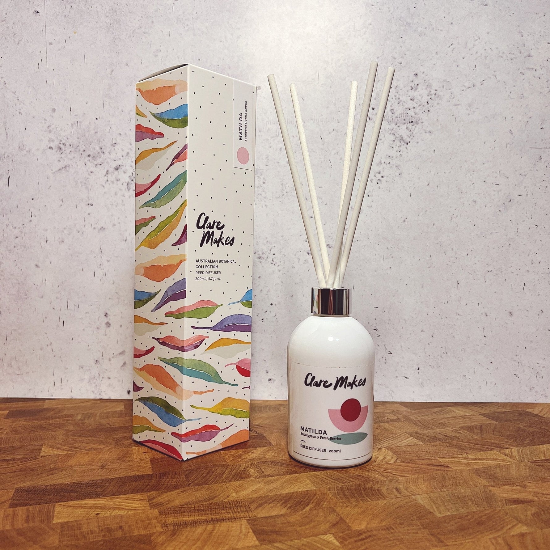 Clare Makes 200ml reed diffuser in a gloss white glass bottle with silver collar and white reeds
