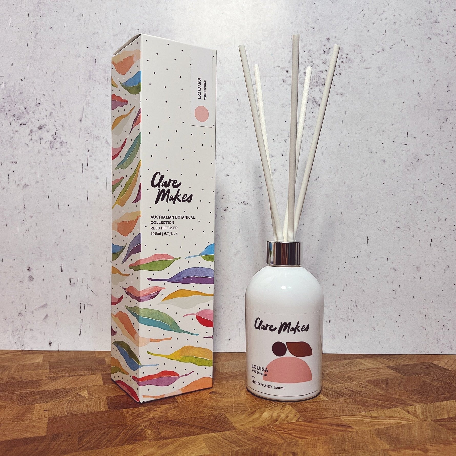Clare Makes 200ml reed diffuser in a gloss white glass bottle with silver collar and white reeds