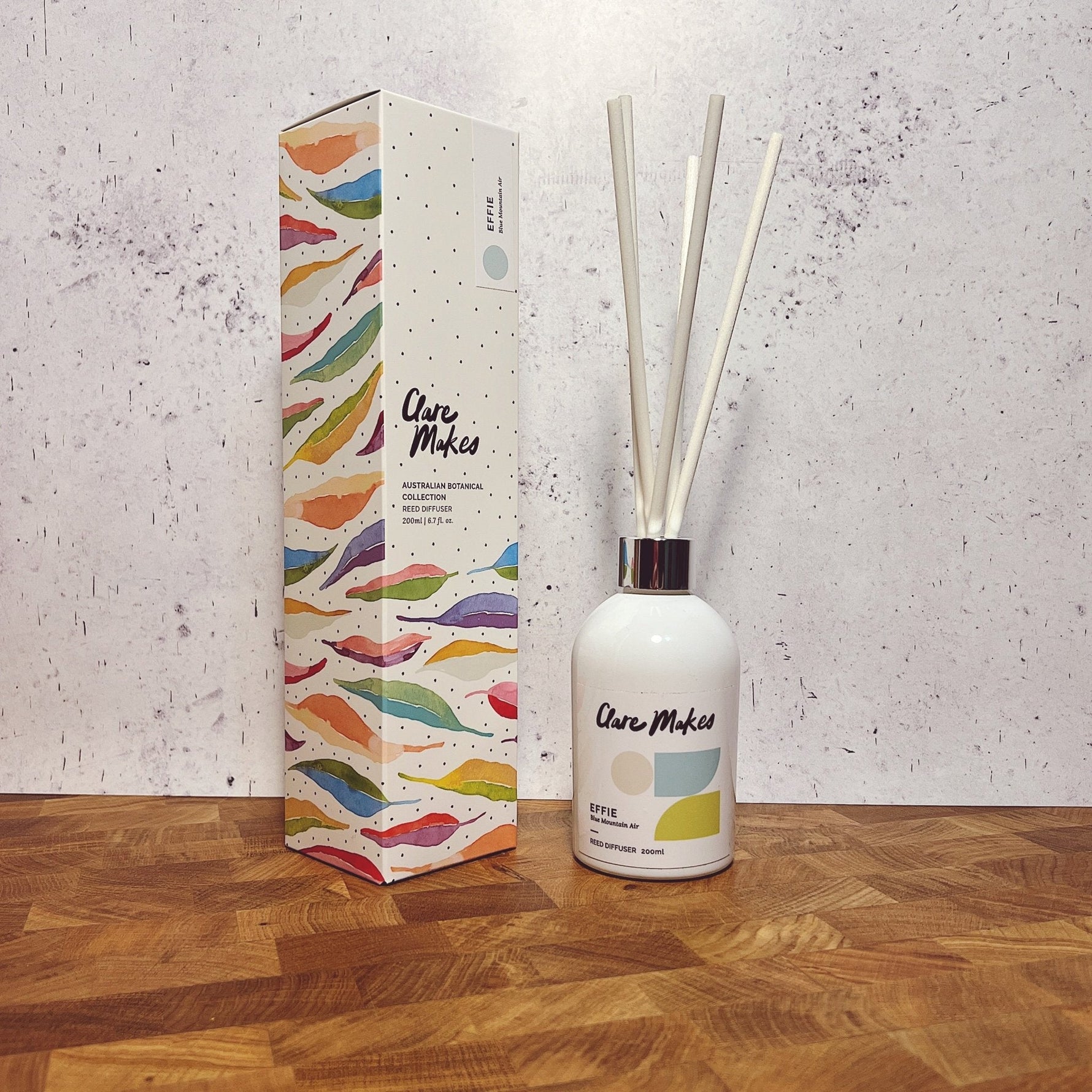 Clare Makes 200ml reed diffuser in a gloss white glass bottle with silver collar and white reeds
