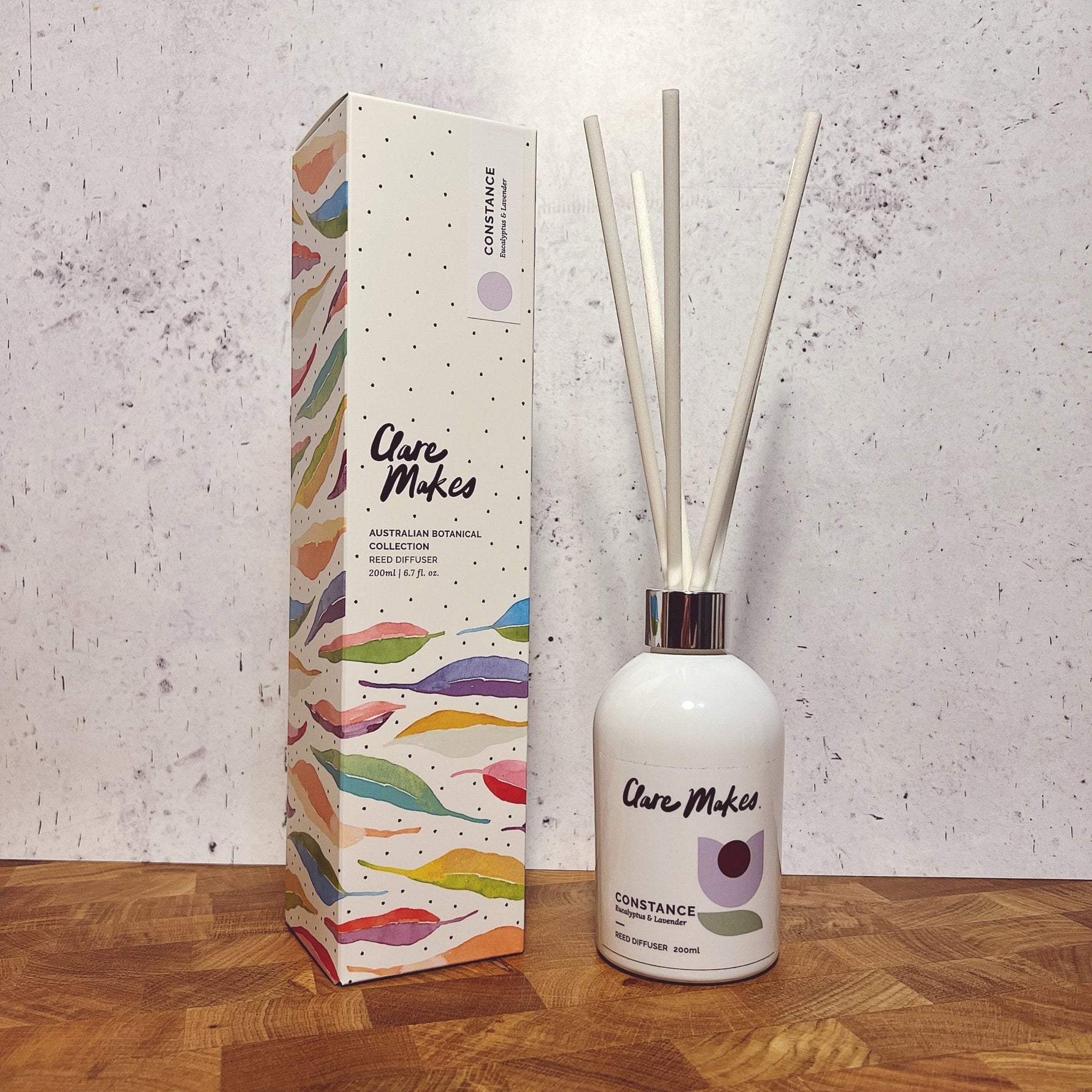 Clare Makes 200ml reed diffuser in a gloss white glass bottle with silver collar and white reeds