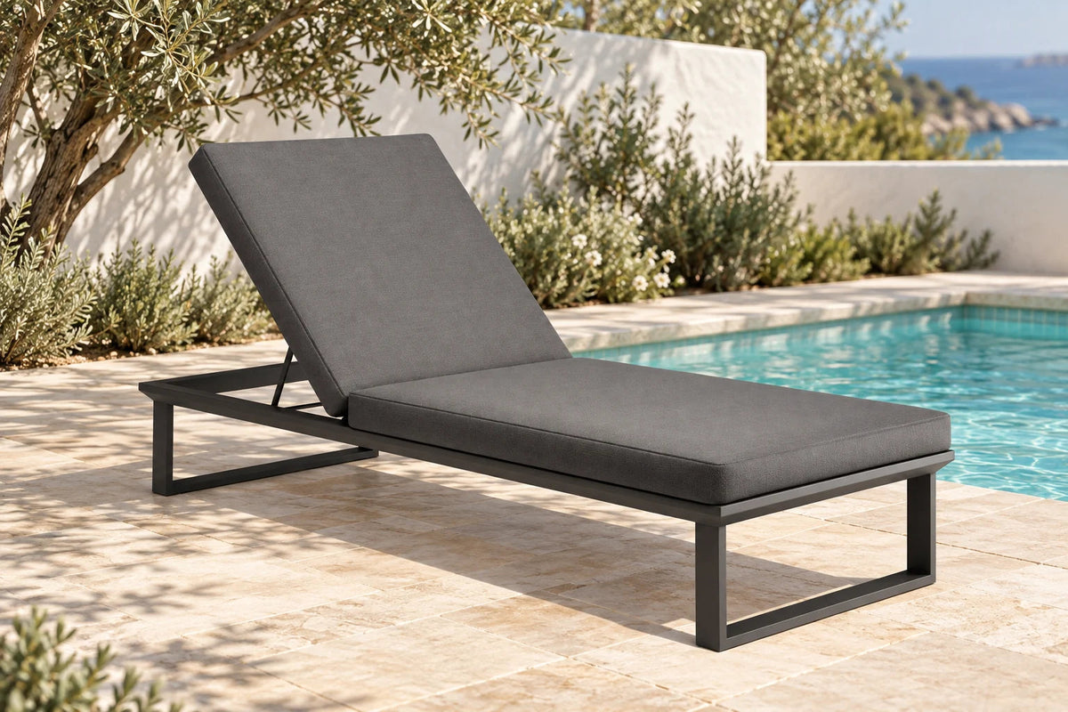 Solenne charcoal sun lounge beside a pool