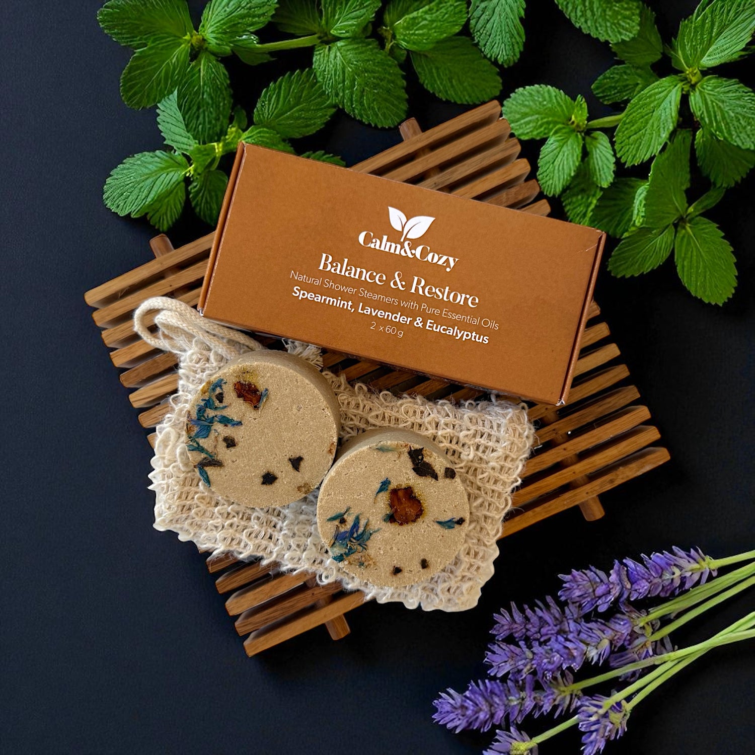 Calm & Cozy Balance & Restore product with decorative soap and lavender on a dark background