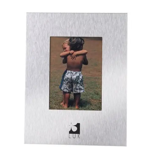 Silver aluminium photo frame showcasing children hugging in a black velvet setting