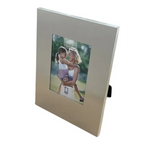 Modern aluminium photo frame displaying a romantic couple’s picture on black velvet